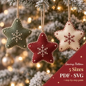 May include: Three star-shaped felt ornaments in olive green, deep red, and cream, each featuring hand-stitched snowflake embroidery and decorative edge stitching. Text reads: Sewing Pattern 5 Sizes PDF SVG + step-by-step guide.