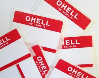 May include: A collection of red and white name tags. Each tag has a red rectangular top with the text "OHELL my name is" in white. The tags are blank below the red section, ready for personalization.