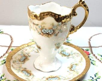 Antique Elite Works Limoges Jeweled Footed Chocolate Cup and Saucer Set, Applied Raised Enamel Forget Me Nots, Gold Tulip Base 1892-1896