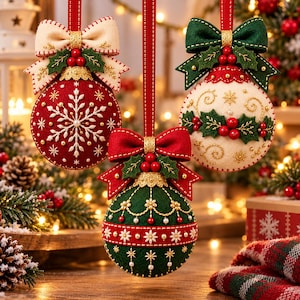 May include: Three round felt Christmas ornaments hanging by red ribbons. One is red with white snowflake embroidery, one is cream with green holly and red berries, and one is green with gold floral embroidery and red ribbon accents.