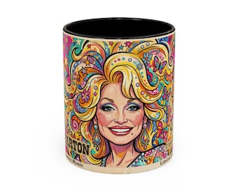 May include: A ceramic mug with a black interior and rim, featuring a vibrant, colorful illustration of a blonde person with voluminous hair, surrounded by butterflies, stars, and floral patterns. The text PARTON is visible on the side.