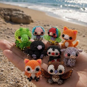 May include: A collection of small, handcrafted animal figurines made from tiny, colorful beads. The set includes a green dinosaur, a black bird, a penguin, an orange cat, a fox, an owl, and other creatures, all featuring large, dark, round eyes.