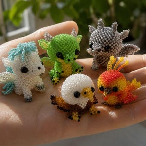 May include: Five small, handcrafted beaded figurines featuring a white and blue unicorn, a green dragon, a grey creature with wings, a brown and white eagle, and a red and yellow bird, all with black bead eyes, resting together in a palm.