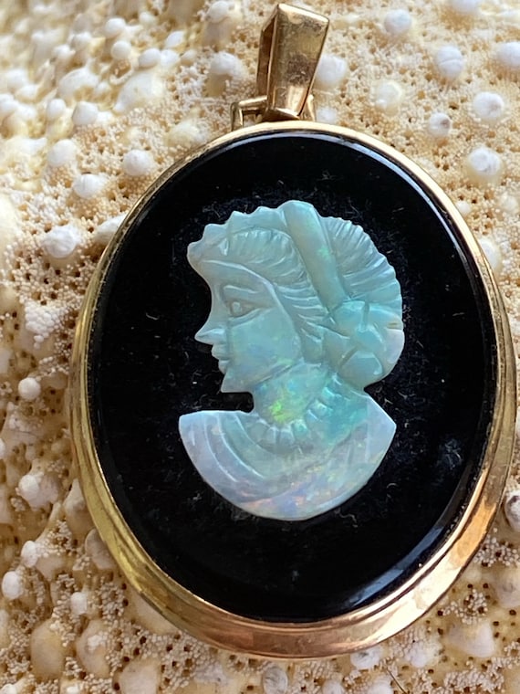 Gorgeous vintage cameo featuring a carved opal inl