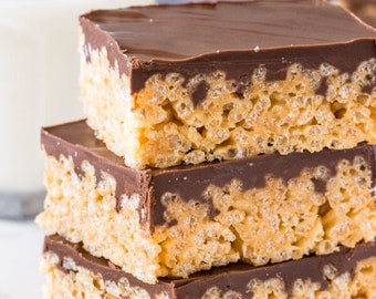 May include: A stack of three chocolate-covered rice crispy treats. The treats are square-shaped and have a smooth chocolate topping. The treats are sitting on a white surface.