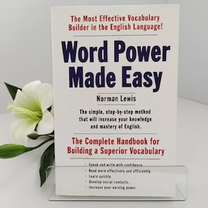 May include: A paperback book titled Word Power Made Easy by Norman Lewis with a white cover, dark blue text, and red accents. The cover features the subtitle The Most Effective Vocabulary Builder in the English Language and a white lily.