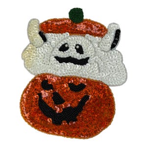 May include: A decorative patch featuring a white sequined ghost wearing an orange sequined beret with a green bead top. Below the ghost is a large orange sequined pumpkin with a black beaded jack-o'-lantern face and a wide, smiling mouth.