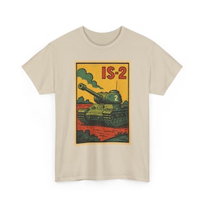 May include: A beige t-shirt featuring a rectangular graphic print of a green IS-2 tank on a red ground with a yellow sky. The tank has the number 2 on its turret. The text IS-2 is printed in red in the upper right corner of the graphic.