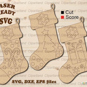 May include: Three Christmas stocking SVG cut files with different designs. The first stocking has a snowflake and candy canes. The second stocking has a snowflake, a star, and a Christmas tree. The third stocking has a snowflake, a gift box, and stars. The text "Cut" and "Score" are shown in black and red squares, respectively.