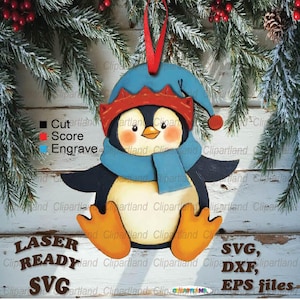 Peut inclure: Ornement de Noël en bois en forme de pingouin. Le pingouin porte un bonnet bleu, une écharpe et une bordure de chapeau rouge. Le pingouin a des pieds orange et un ruban rouge pour l'accrocher. Prêt pour le laser, fichiers SVG, DXF et EPS.