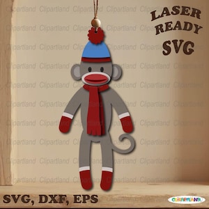 May include: A gray sock monkey ornament with a red scarf, hat, and mittens. The monkey has a red mouth and white accents. The text "LASER READY SVG" and "SVG, DXF, EPS" are also visible.