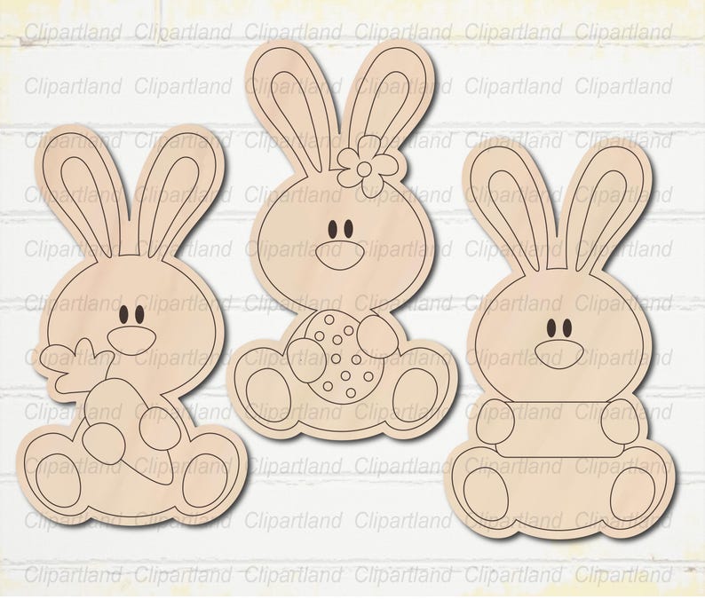 May include: Three wooden Easter bunny cutouts. The bunnies have large ears, round bodies, and smiling faces. One bunny holds a carrot, another holds an Easter egg, and the third has a blank space for customization. The cutouts are light brown.