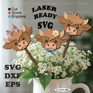 May include: Three brown cow head cutouts on sticks, each with a different accessory: a pink bow, a blue bow, and a white flower. The text "LASER READY SVG" is above the cow heads. The image is set against a background of white flowers in a white pitcher.