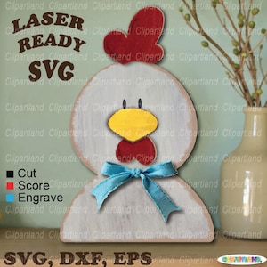 May include: Wooden chicken-shaped decoration with a red comb and wattle, yellow beak, and blue bow. The text "LASER READY SVG" is displayed. The design is suitable for cutting, scoring, and engraving.