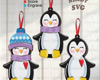 May include: Three penguin ornaments for a Christmas tree. The penguins are wearing hats and scarves. The ornaments are laser cut and ready to be assembled. The text "LASER READY SVG" is at the top of the image.