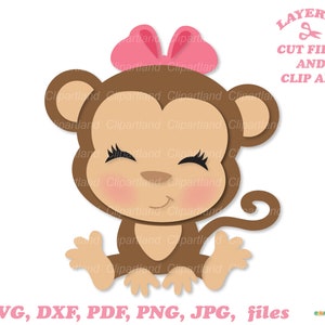 May include: A brown monkey with a pink bow on its head. The monkey is sitting with its legs crossed and its arms outstretched. The monkey has a happy expression on its face.