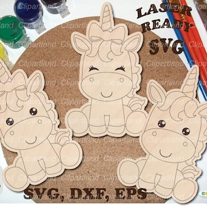 May include: Three wooden unicorn cutouts with bows, horns, and smiling faces are arranged on a corkboard. The words "LASER READY SVG" are visible. Paintbrushes and paint pots surround the unicorns, suggesting a craft project.