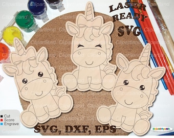 May include: Three wooden unicorn cutouts with bows, horns, and smiling faces are arranged on a corkboard. The words "LASER READY SVG" are visible. Paintbrushes and paint pots surround the unicorns, suggesting a craft project.