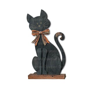 May include: Black wooden cat figurine with an orange and brown bow. The cat is sitting on a wooden base.