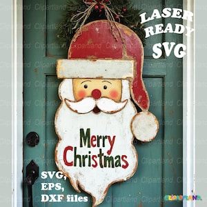 May include: A wooden Santa Claus face decoration with a red hat and white beard. The words "Merry Christmas" are displayed in green and red. The image also includes the text "LASER READY SVG" and "SVG, EPS, DXF files".