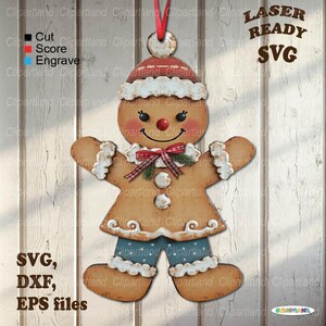 May include: A gingerbread man ornament with a red and white hat, a red bow tie, and blue pants. The ornament has a smiling face with black eyes and a red nose. The text "LASER READY SVG" is visible.