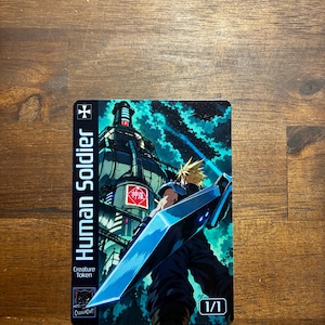 May include: A rectangular trading card featuring a spiky-haired character holding a large blue sword, standing before a tall industrial tower under a dark teal sky. The card text reads Human Soldier, Creature Token, and 1/1 with a small logo.