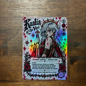 May include: A holographic trading card titled Kaalia of the Vast featuring a white-haired character holding a sword, surrounded by red rose and thorn motifs with blood splatter effects. The card text includes Flying, Legendary Creature, and 2/2.