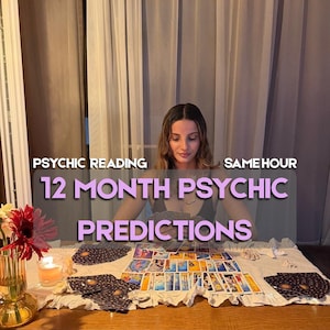 May include: A collection of tarot cards spread across a white cloth, featuring the text "PSYCHIC READING SAME HOUR" and "12 MONTH PSYCHIC PREDICTIONS" in white and purple lettering. A glass vase with red and white flowers sits beside a lit candle.