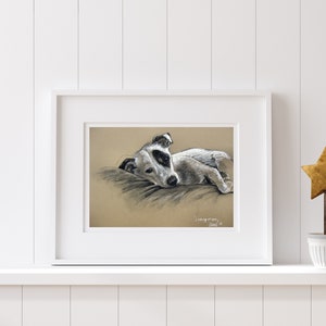 Print of a Terrier dog charcoal and chalk sketch in a white frame on a white shelf