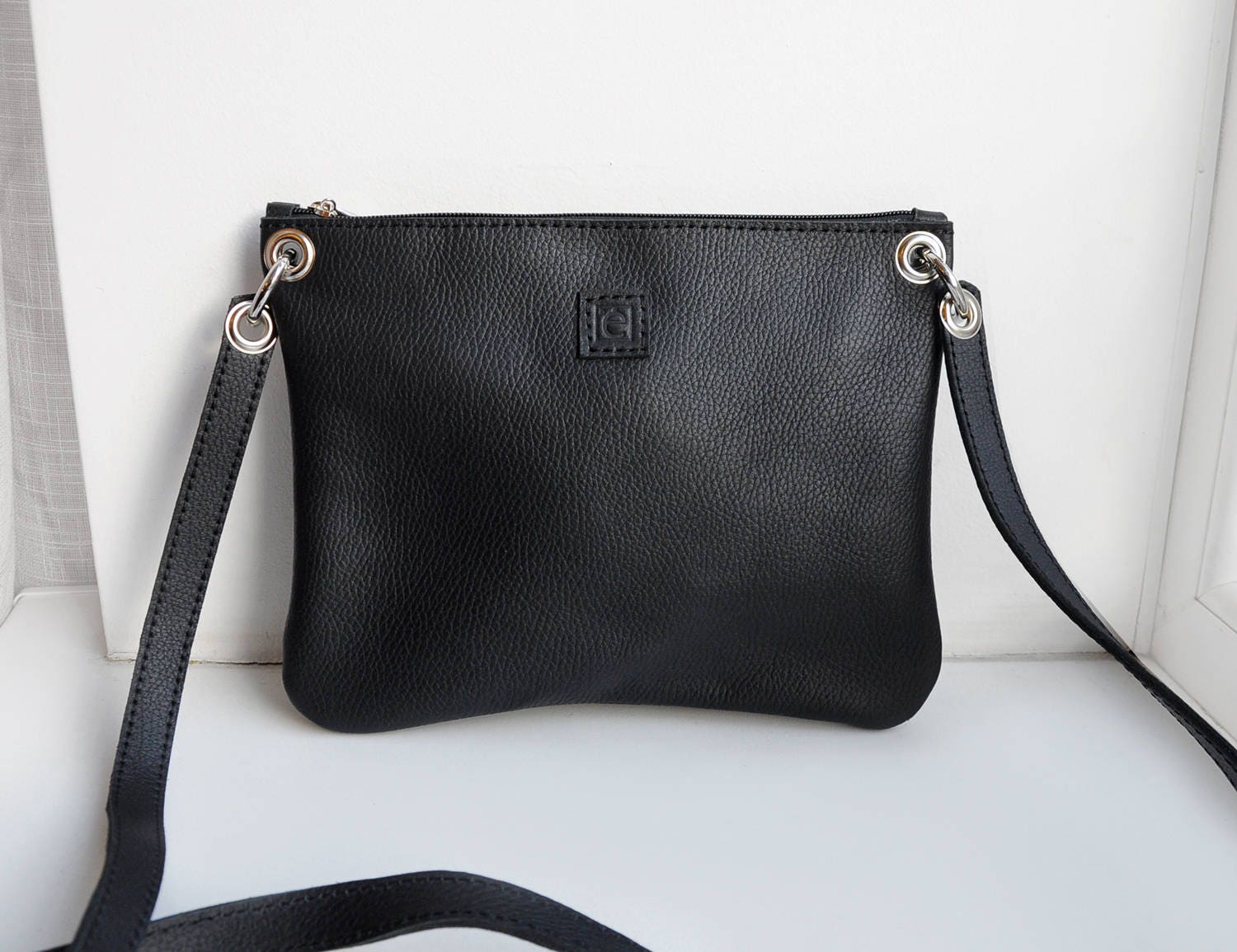 Simple black leather crossbody bag with zipper