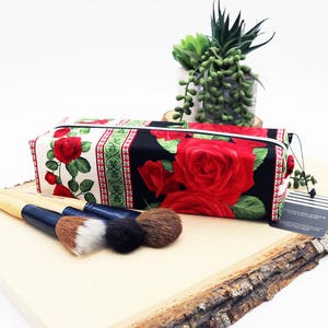 May include: A handmade, wooden serving tray with a natural finish. The tray features a rectangular shape with rounded corners and two carved handles. The wood grain is visible, adding to its rustic charm. Perfect for serving food or displaying items.