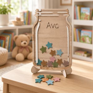 May include: A wooden jar-shaped reward board with the name Ava engraved at the top. The board features white painted accents and contains several small, colourful wooden stars in shades of blue, green, brown, and pink, with additional stars placed in front.