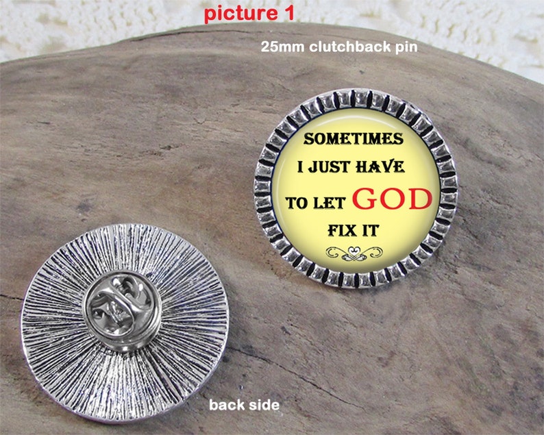 May include: A silver pin with a yellow background and black text that reads 'Sometimes I just have to let GOD fix it.' The pin has a silver clutchback on the back side.