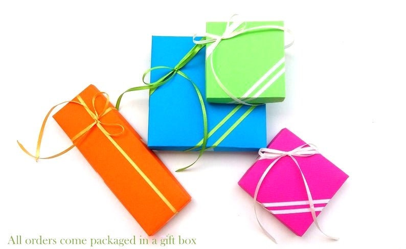 May include: Four gift boxes wrapped in different colors: orange, blue, green, and pink. Each box is tied with a ribbon and bow.