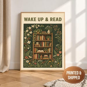 May include: A rectangular wall art print featuring the text WAKE UP & READ in dark green letters. The illustration depicts a wooden bookshelf filled with books, potted plants, and a small vase, surrounded by a lush border of colourful flowers and vines.
