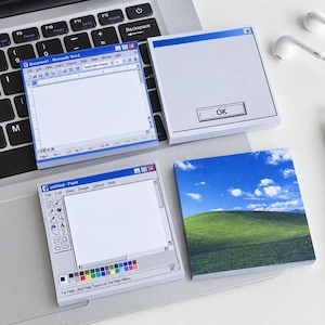 May include: Four square sticky notes featuring retro computer interface designs. One shows a Microsoft Word document window, another a pop-up box with OK, a third displays an untitled Paint program, and the fourth depicts a green hill landscape.