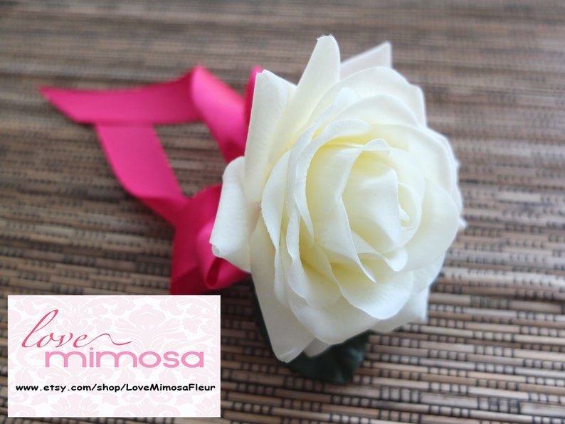 Wrist Corsage Ivory Rose with fuchsia ribbon on pearl bracelet