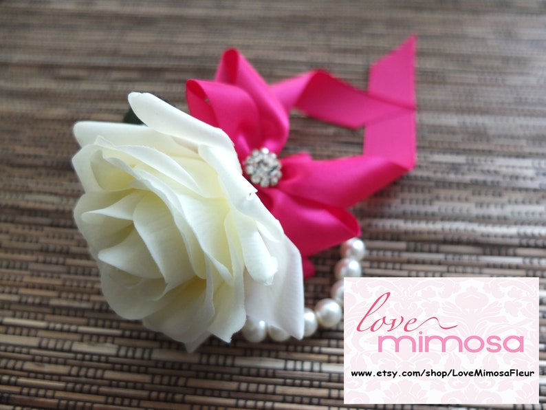 Wrist Corsage Ivory Rose with fuchsia ribbon on pearl bracelet