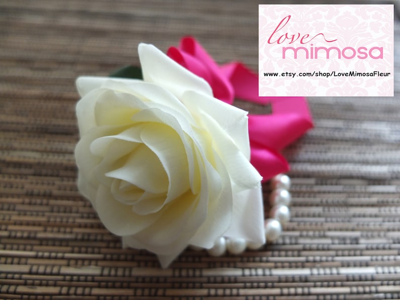 Wrist Corsage Ivory Rose with fuchsia ribbon on pearl bracelet