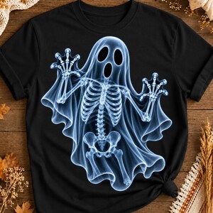May include: A black short-sleeved t-shirt featuring a large, light blue, glowing X-ray style graphic of a ghost with a visible human-like rib cage, spine, and pelvic bone structure, with arms raised and fingers spread in a spooky, reaching pose.