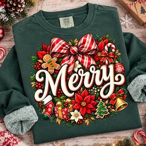 May include: A dark green long-sleeve sweatshirt featuring a large graphic of a Christmas wreath with the word Merry in white script. The wreath includes a red and white striped bow, a gingerbread man, a stocking, a gift, and a gold bell.