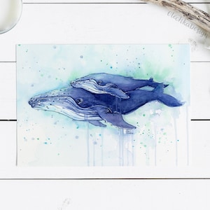 May include: Watercolor painting of two blue whales swimming together. The larger whale is in the foreground and the smaller whale is swimming on top of it. The painting has a light blue background with green and blue watercolor splatters.