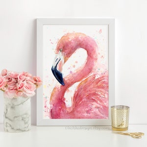May include: A watercolor painting of a pink flamingo with a blue beak, set against a white background with colorful watercolor splatters. The painting is framed in a white frame.