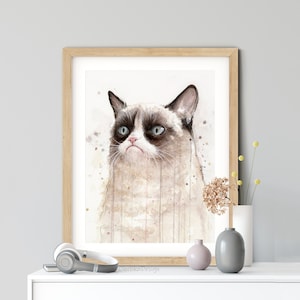 May include: A watercolor painting of a grumpy cat with brown and white fur. The cat has a serious expression and is looking to the left. The background is a light brown with watercolor splatters.