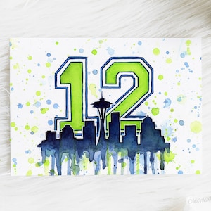 May include: Watercolor painting of the number 12 in green and blue with a silhouette of the Seattle skyline, including the Space Needle, in the center. The background is white with blue and green watercolor splatters.