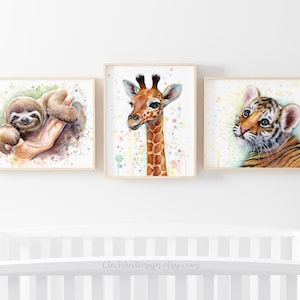 May include: Three watercolour paintings of baby animals in frames. The first painting features a sloth with a green background. The second painting features a giraffe with a white background and colourful dots. The third painting features a tiger with a white background and colourful dots.