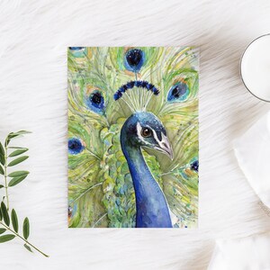 May include: A watercolor painting of a peacock with a blue head and neck, and a green, blue, and yellow tail. The peacock's feathers are spread out in a fan shape.