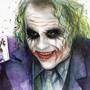 May include: Watercolor painting of the Joker from the movie The Dark Knight. He is holding a playing card with the Joker on it. The background is white with colorful splatters of paint.