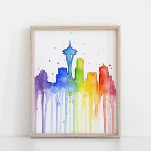 May include: A watercolor painting of the Seattle skyline in rainbow colors with the Space Needle in the center. The colors drip down the page, creating a vibrant and colorful image.
