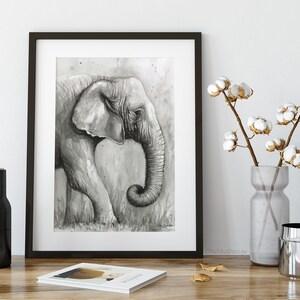 May include: Black and white watercolour painting of an elephant's head and trunk. The elephant is facing left and its trunk is curled up. The background is a light grey with a watercolour wash.